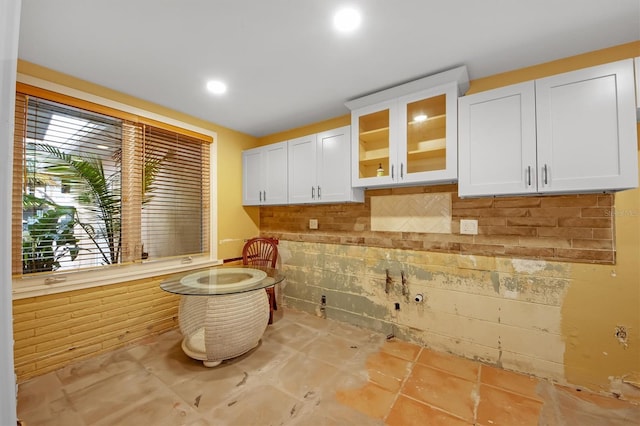 kitchen featuring decorative backsplash and white cabinets