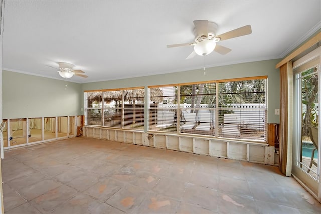 unfurnished sunroom featuring ceiling fan