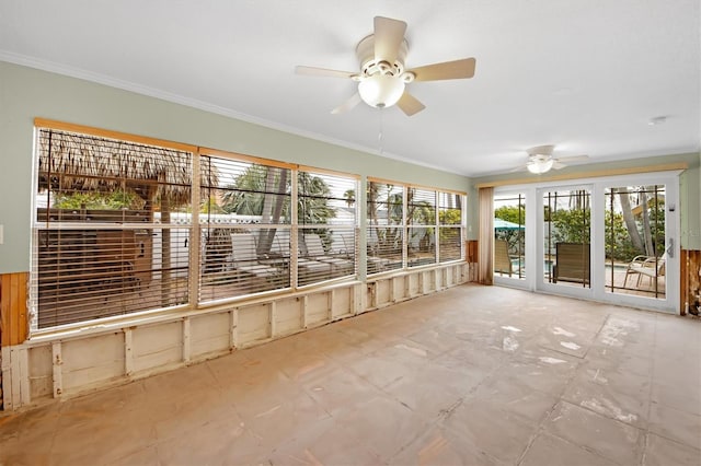 unfurnished sunroom with ceiling fan