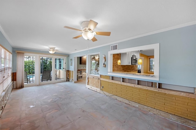 unfurnished living room with crown molding and ceiling fan