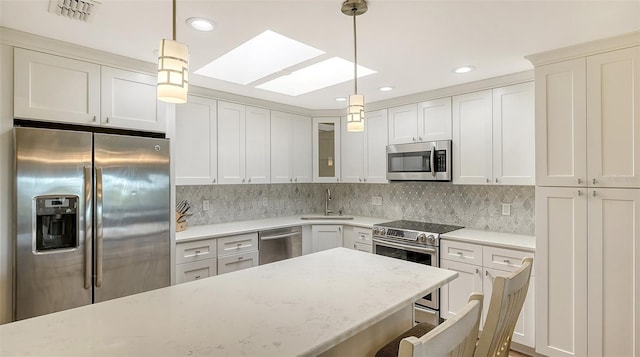 kitchen with glass insert cabinets, visible vents, appliances with stainless steel finishes, and pendant lighting