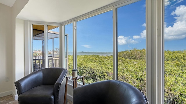 sunroom / solarium with a water view