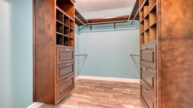 spacious closet with wood finished floors