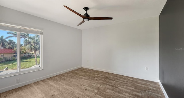 unfurnished room with ceiling fan, baseboards, and wood finished floors