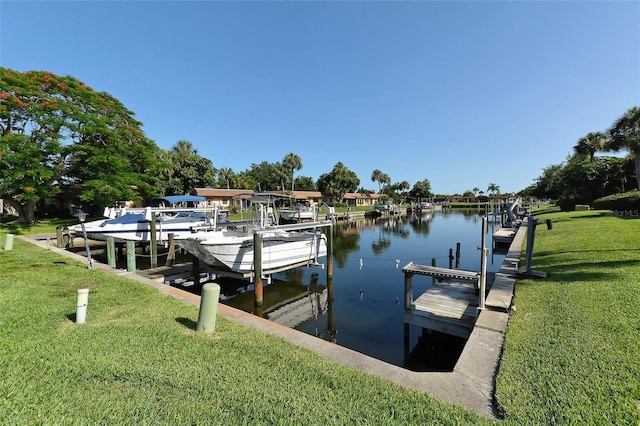 dock area with a lawn, a water view, and boat lift