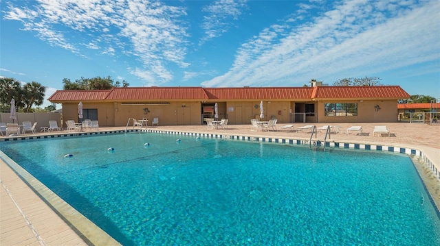 community pool featuring a patio area and fence