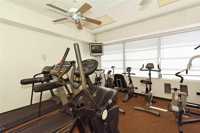 workout area featuring baseboards and a ceiling fan