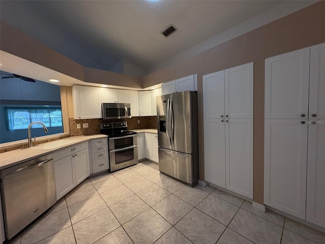 kitchen with white cabinetry, sink, backsplash, and stainless steel appliances