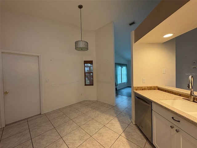 kitchen featuring lofted ceiling, sink, decorative light fixtures, light tile patterned floors, and stainless steel dishwasher