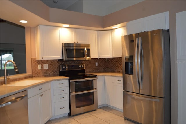 kitchen featuring white cabinetry, sink, decorative backsplash, and stainless steel appliances