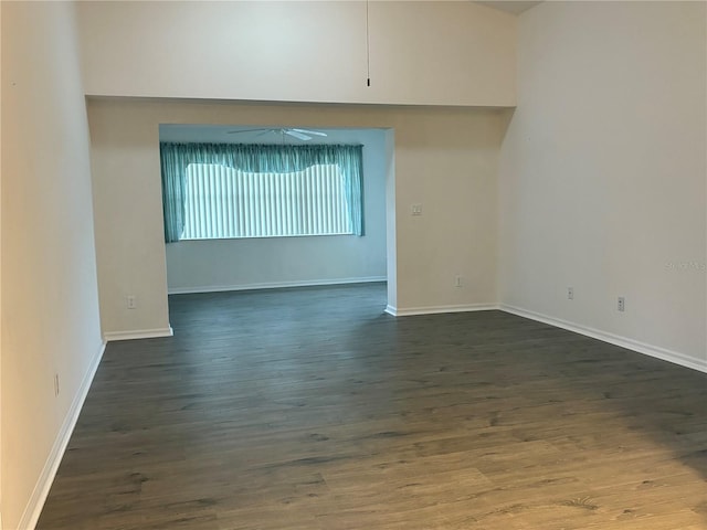 spare room featuring dark hardwood / wood-style flooring and ceiling fan