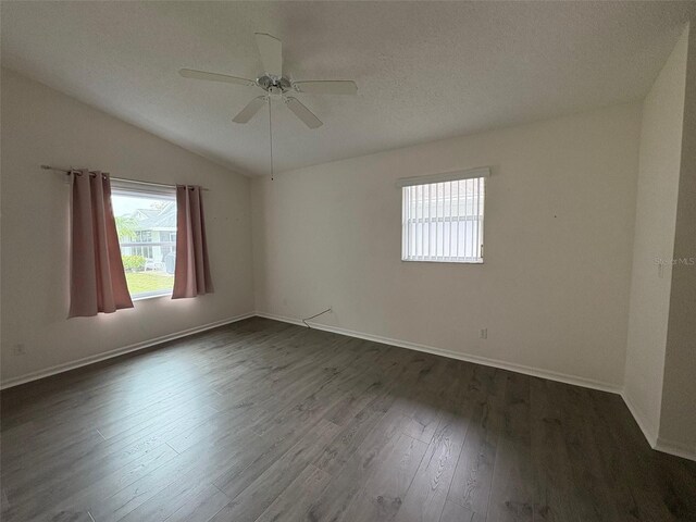 unfurnished room with lofted ceiling, dark wood-type flooring, and ceiling fan