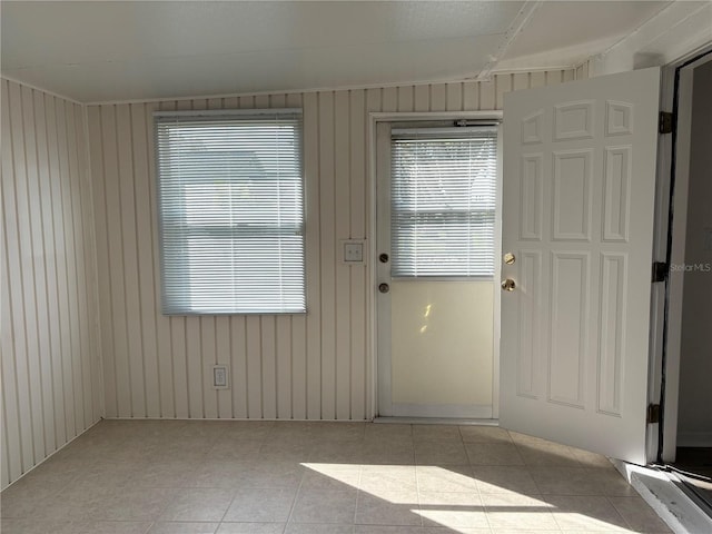 doorway to outside featuring wooden walls