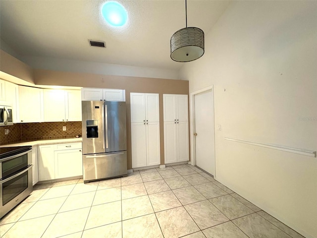 kitchen with stainless steel appliances, light countertops, visible vents, backsplash, and white cabinets