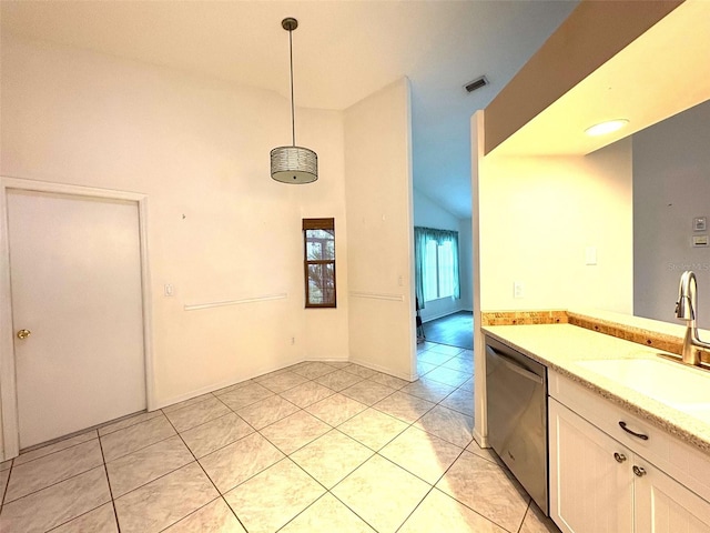 kitchen with light tile patterned floors, dishwasher, light countertops, pendant lighting, and a sink