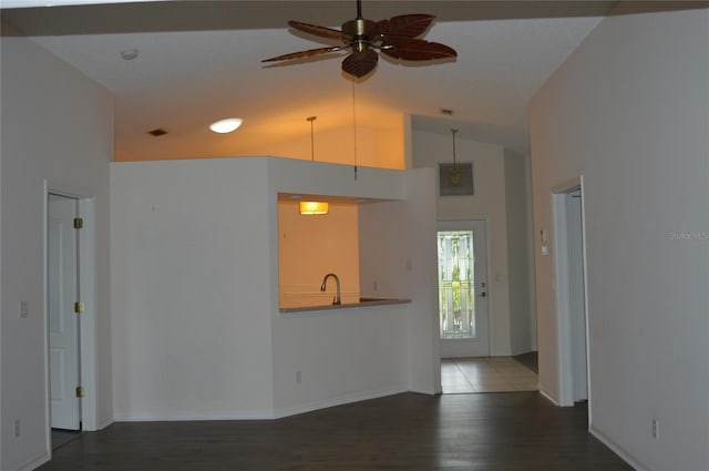 unfurnished living room with vaulted ceiling, ceiling fan, dark wood-type flooring, and visible vents