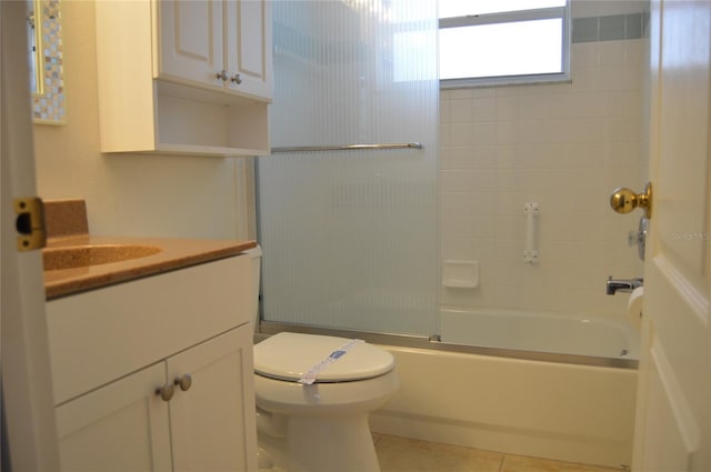 bathroom featuring shower / bath combination with glass door, vanity, toilet, and tile patterned floors