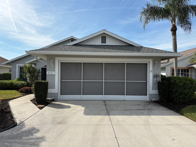 ranch-style home featuring a garage, driveway, a shingled roof, and stucco siding