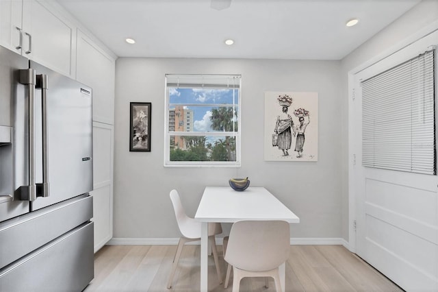 dining space with light wood-style floors, baseboards, and recessed lighting