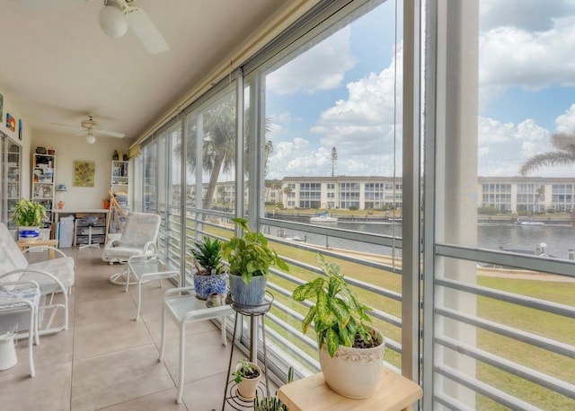 sunroom with a water view and a ceiling fan