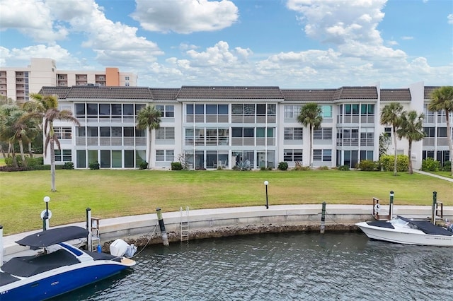 dock area with a yard and a water view