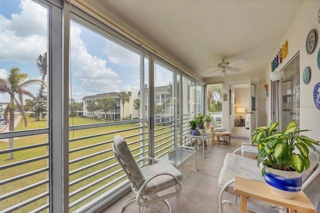 sunroom featuring a ceiling fan