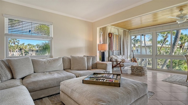 tiled living room featuring ornamental molding, a healthy amount of sunlight, and ceiling fan