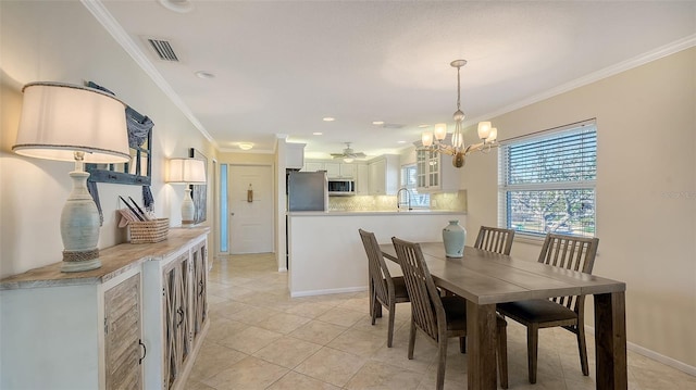 dining room featuring light tile patterned floors, visible vents, ornamental molding, and baseboards