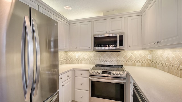 kitchen featuring white cabinetry, decorative backsplash, a textured ceiling, and appliances with stainless steel finishes