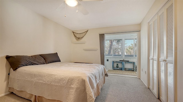 bedroom featuring ceiling fan, a closet, and light carpet