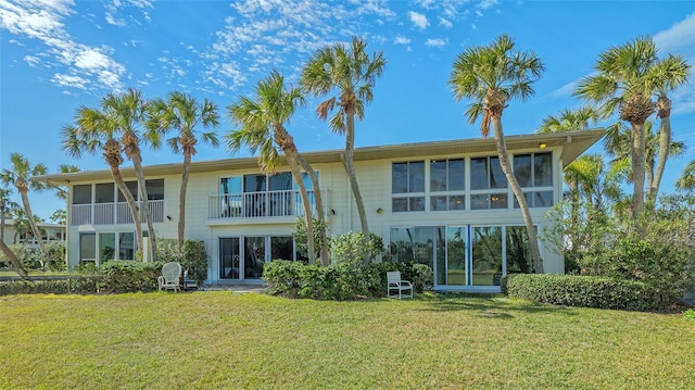 rear view of property with a lawn