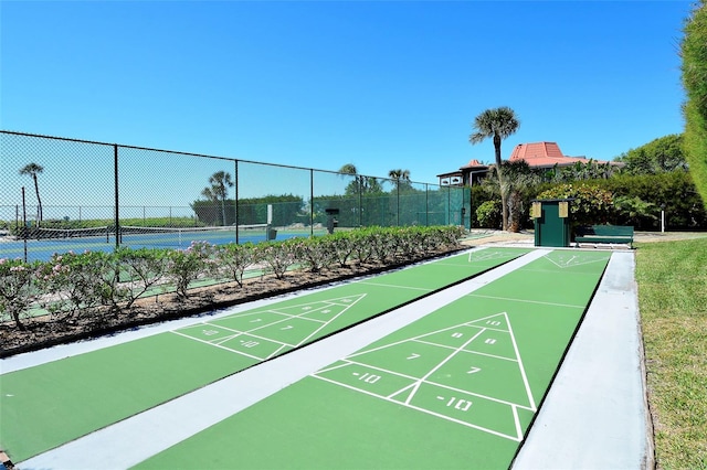 view of home's community featuring shuffleboard and fence