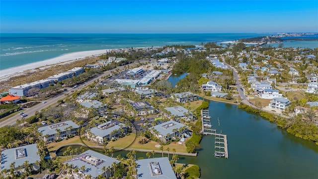 birds eye view of property with a beach view and a water view