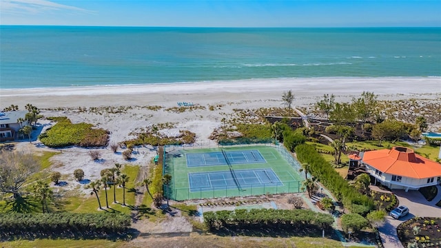 birds eye view of property with a water view and a beach view