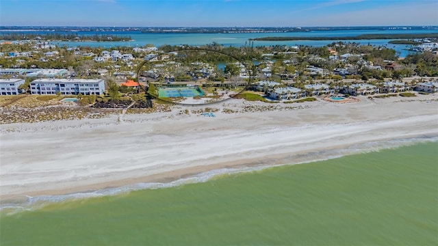 drone / aerial view featuring a water view and a beach view