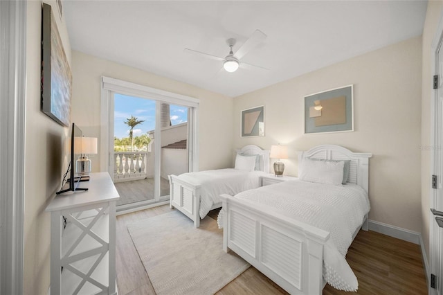 bedroom featuring access to exterior, light hardwood / wood-style floors, and ceiling fan