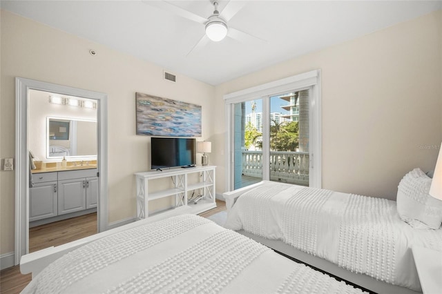 bedroom with hardwood / wood-style floors, ensuite bathroom, access to outside, and ceiling fan