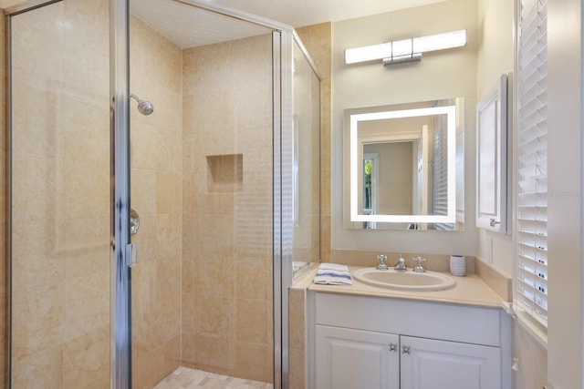 bathroom featuring walk in shower and vanity