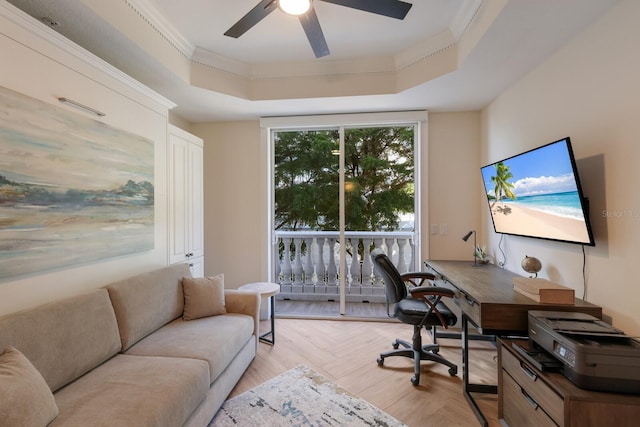 office area featuring a raised ceiling, crown molding, light wood-type flooring, and a wall of windows