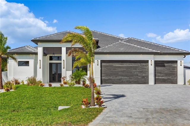 ranch-style house with a garage and a front lawn