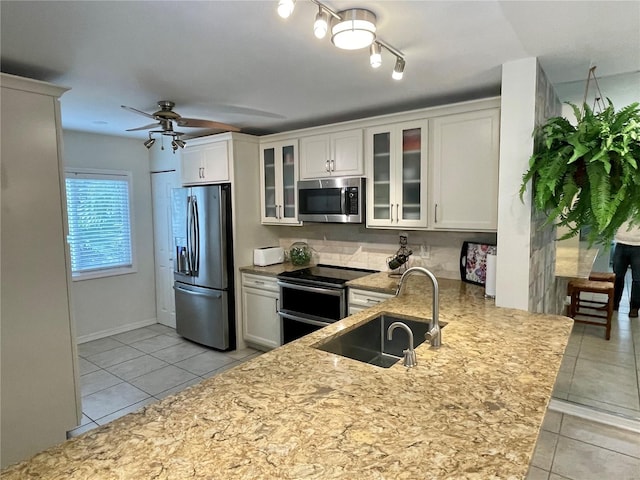 kitchen featuring sink, white cabinetry, appliances with stainless steel finishes, and light tile patterned flooring