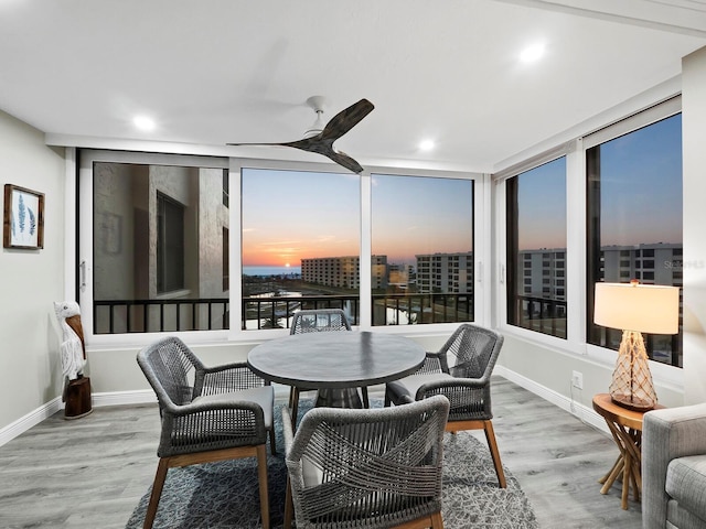 sunroom / solarium featuring ceiling fan