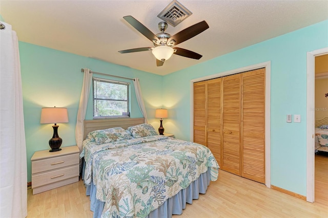 bedroom with a closet, ceiling fan, and light wood-type flooring