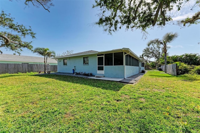 rear view of house with a yard