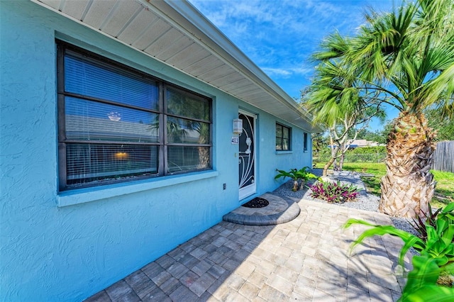 exterior space featuring a patio, stucco siding, and fence