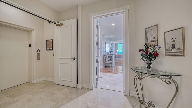 corridor with light tile patterned floors