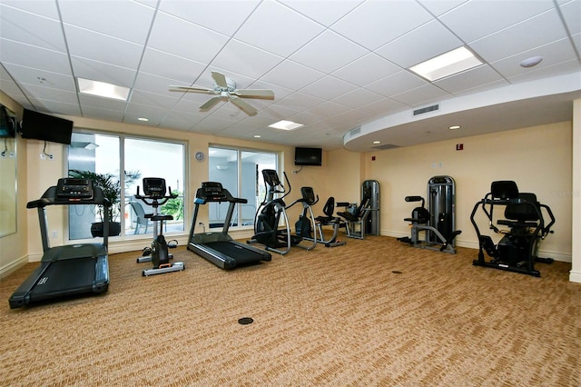 exercise room featuring ceiling fan and carpet