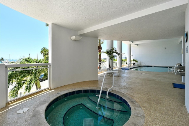 view of pool with an indoor in ground hot tub