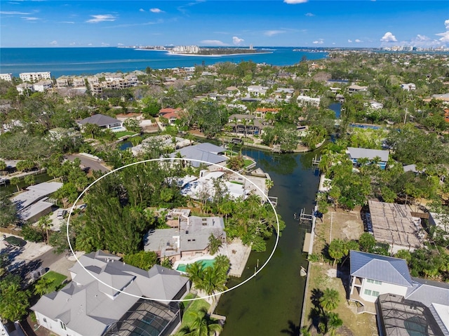 birds eye view of property with a water view