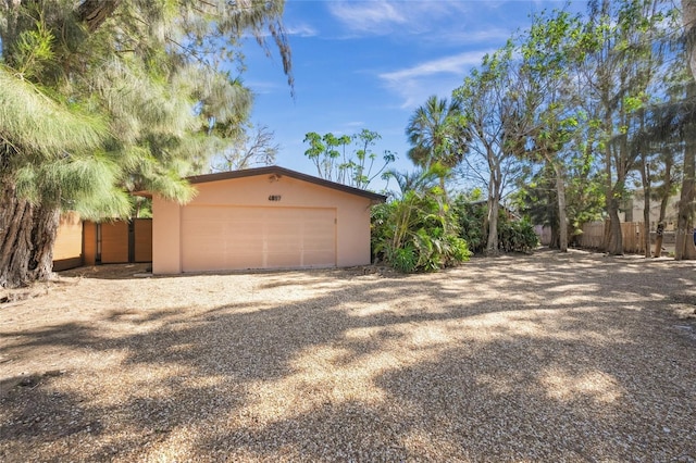 view of home's exterior featuring a garage and an outdoor structure